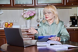 Senior business woman working remotely using laptop for video call