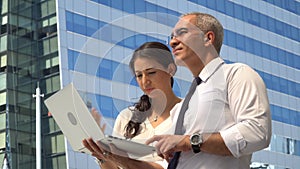 senior businessman and businesswoman meeting with laptop computer on site to inspection or survey location project building in