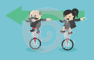 Senior businessman and Businesswoman riding a bicycle holding green arrow