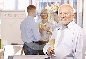 Senior businessman celebrating in office