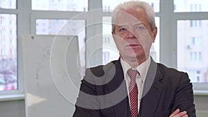 Senior businessman crosses his arms on his chest