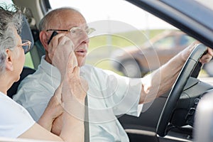 Senior businessman driving while using phone