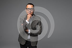Senior businessman in eyesglasses isolated on gray background