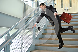 Senior Businessman Falling on Stairs