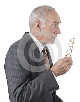 Senior businessman gesturing with glasses