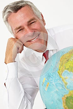 Senior businessman with globe