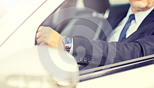 Senior businessman hands driving car