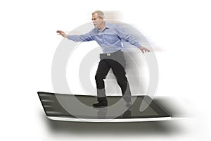 Senior businessman keeping balance on a PC tablet
