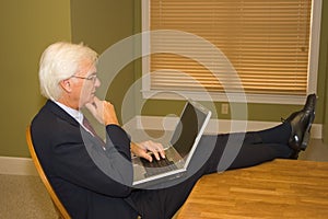 Senior Businessman on Laptop