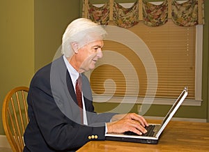 Senior Businessman on Laptop