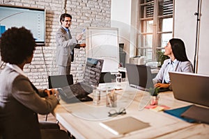 Businessman leading meeting at boardroom table