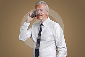 Senior businessman with mobile phone