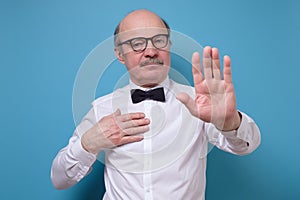 Senior businessman moving away hands palms showing refusal and denial gesture