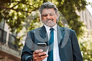 Senior businessman, phone and texting in street with smile, thinking and communication on internet. Mature entrepreneur