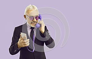 Senior businessman talk on cellphone with corded headset