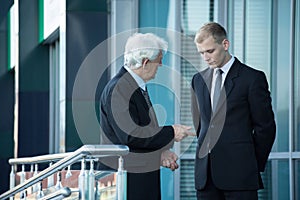 Senior businessman talking with his employee