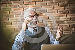 Senior businessman talking phone. Happy and smiling.