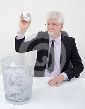 Senior businessman throwing paper