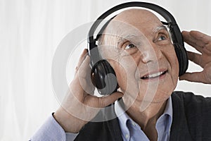 Senior Businessman Wearing Headphones