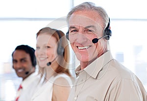 Senior businessman working in a call center