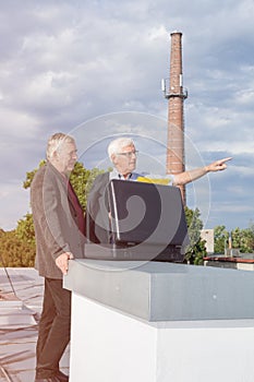 Senior businessmen discussing business on the roof of a building