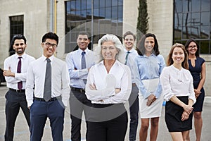 Senior businesswoman and colleagues outdoors, portrait