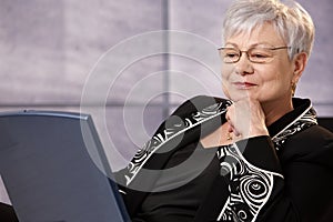 Senior businesswoman looking at computer screen