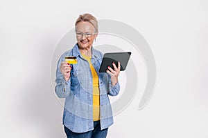 Senior businesswoman making online payment with credit card over digital tablet on white background