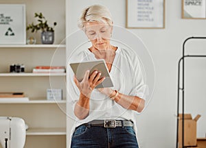 Senior businesswoman, manager or designer reply, responding or sending notification of online orders from handheld