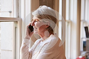 Senior Businesswoman On Mobile Phone In Office