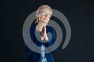 Senior businesswoman praying