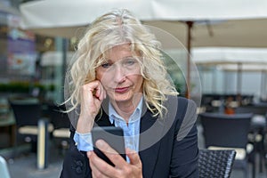Senior businesswoman reading a text message