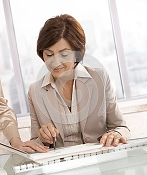 Senior businesswoman reviewing documents