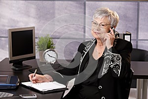 Senior businesswoman using cellphone