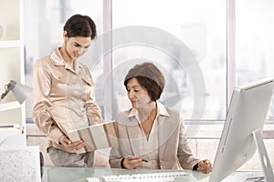 Senior businesswoman working with assistant