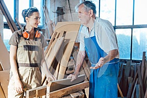 Senior carpenter sharing wisdom with younger aspiring colleague