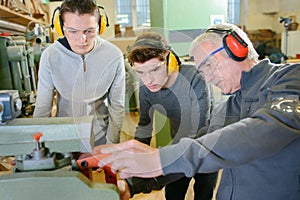 Senior carpenter with two learners