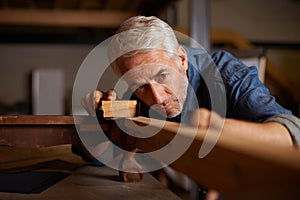 Senior carpenter, wood sanding and man with precision on building construction and architecture project. Home