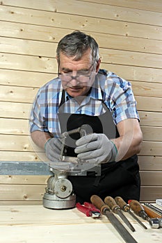 Senior carpenter working in his workshop