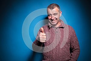 Senior casual man shows thumb up