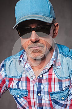 Senior casual man wearing baseball hat and sunglasses