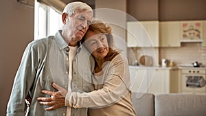 Senior caucasian couple hugging each other at home