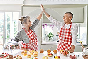 Senior caucasian couple smiling happy baking sweets