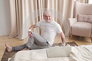 Senior caucasian man doing yoga Spine twisting pose