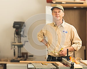 Senior caucasian man in home workshop with voting sticker