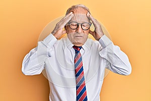 Senior caucasian man wearing business clothes with hand on head, headache because stress