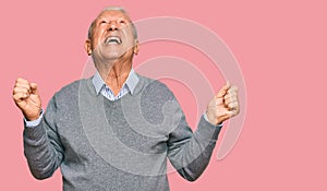 Senior caucasian man wearing casual clothes crazy and mad shouting and yelling with aggressive expression and arms raised