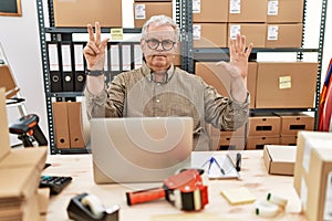 Senior caucasian man working at small business ecommerce with laptop showing and pointing up with fingers number eight while
