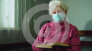 Senior caucasian woman in protective mask on her face reading book themes of retired pensioner