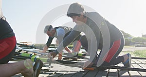 Senior caucasian woman and teammates preparing rowing boat in a river